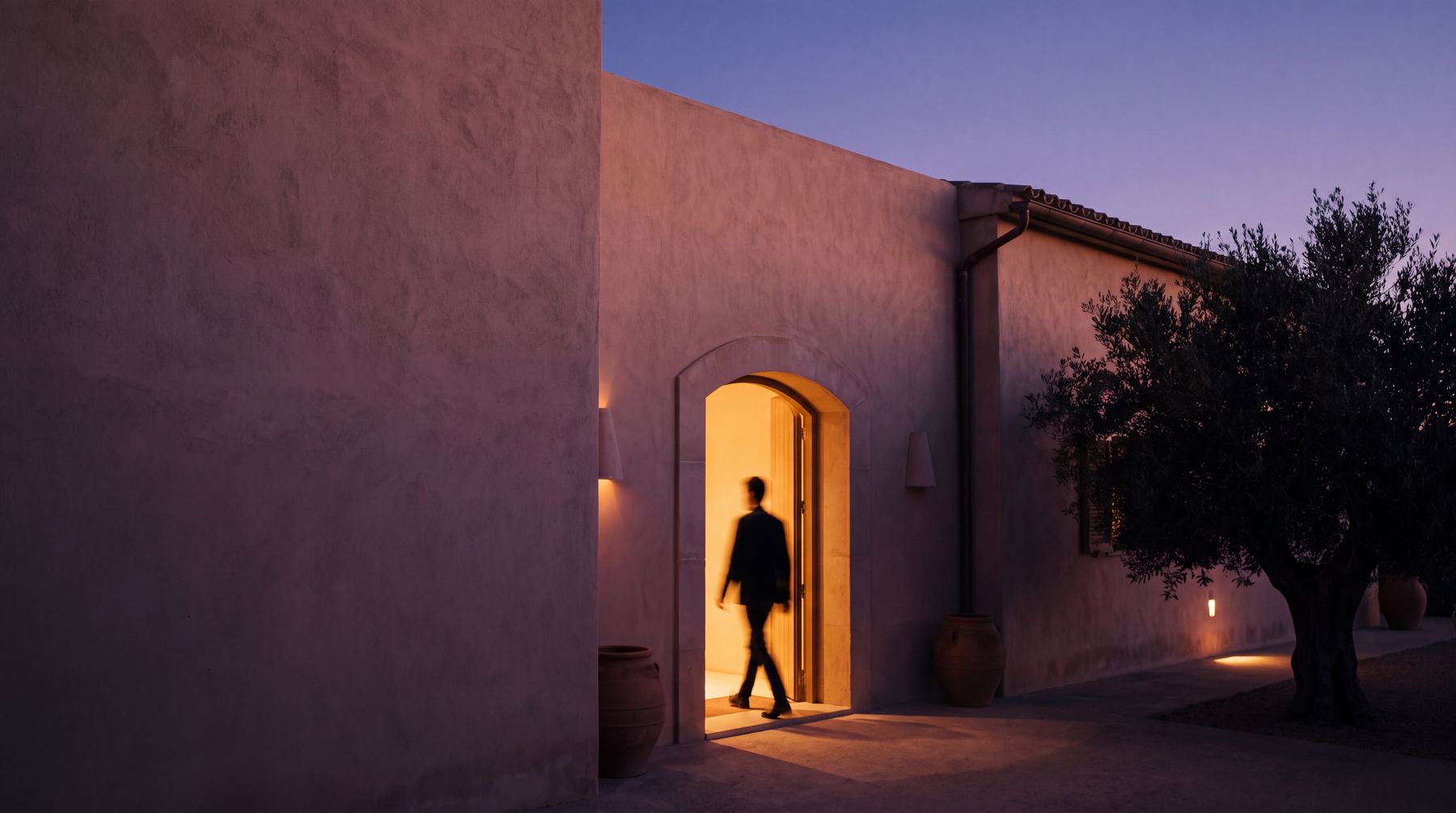 The discreet entrance of a Mediterranean club at dusk.