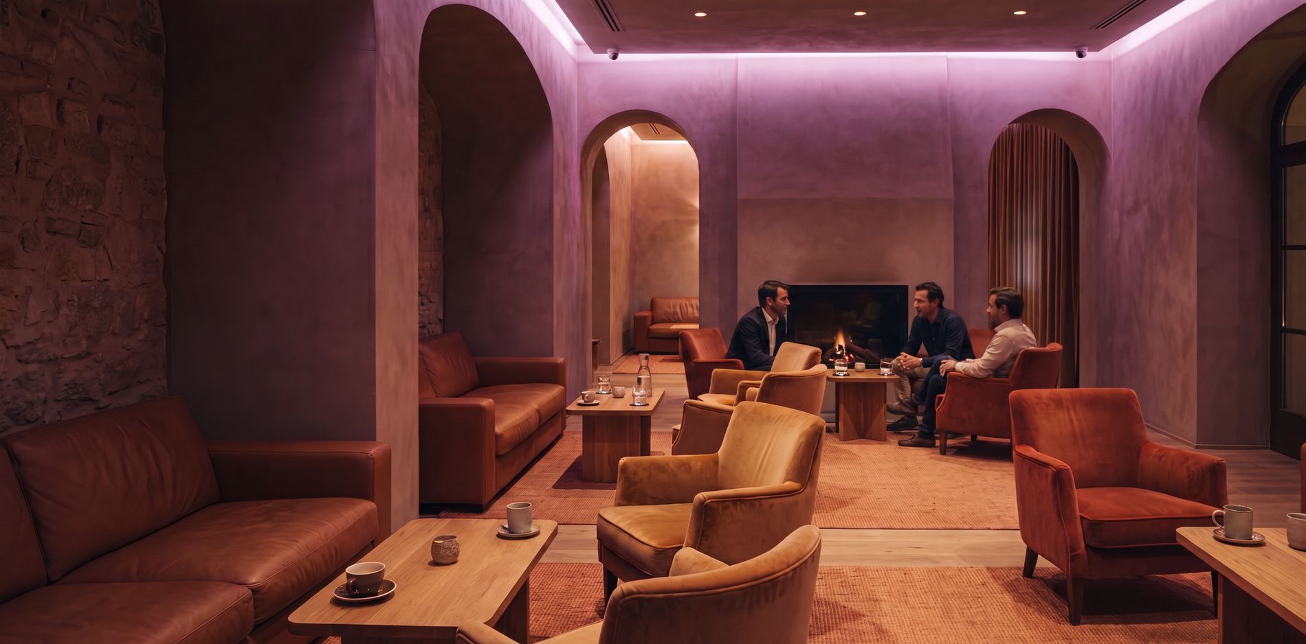 Members in the lounge of a club by the fireplace.